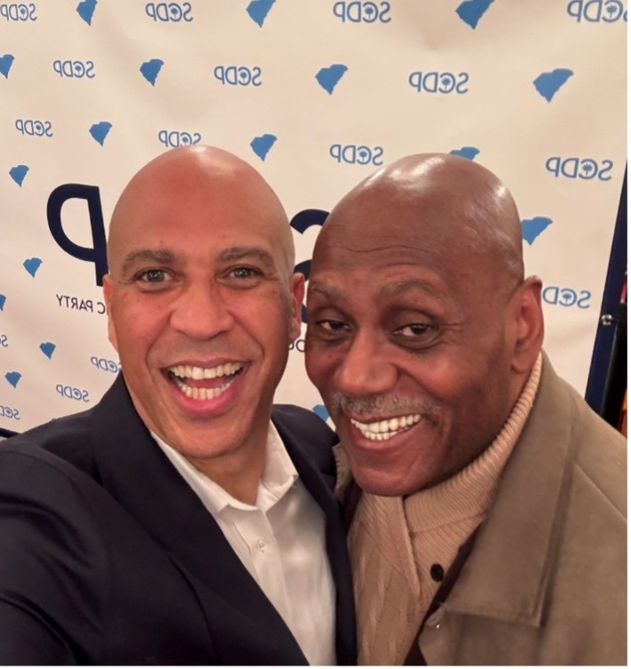 Duane “Duke” Sevillian, board member of Urban Missiology International, pictured with Senator Cory Booker at a community event
