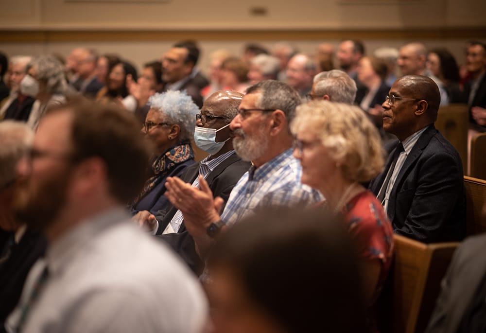 Audience members attending a Catholic theological gathering during a church event on Black theology and Black Christian perspectives.