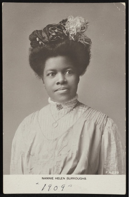 Nannie Helen Burroughs later in life, seated at a desk, representing her lasting legacy in Black history, education, and labor rights.